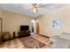 Bright living room with a ceiling fan, tile floors, and a decorative area rug at 725 Ingham Rd, New Smyrna Beach, FL 32168
