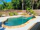 Inviting backyard pool with waterfall feature and stone surround, perfect for relaxation and outdoor entertainment at 725 Ingham Rd, New Smyrna Beach, FL 32168