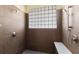 Tiled shower with glass block window and dual shower heads at 725 Ingham Rd, New Smyrna Beach, FL 32168