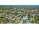 Wide shot of home in a neighborhood with trees and views of the surrounding community at 902 Conrad Dr, New Smyrna Beach, FL 32168