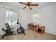 Bedroom with exercise equipment and a ceiling fan at 902 Conrad Dr, New Smyrna Beach, FL 32168