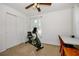 Bedroom showing exercise equipment, ceiling fan and closet at 902 Conrad Dr, New Smyrna Beach, FL 32168