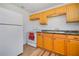 Functional kitchen equipped with wooden cabinets, granite countertops, and modern appliances at 902 Conrad Dr, New Smyrna Beach, FL 32168