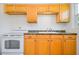 Kitchen features wooden cabinets, granite countertops, and modern white appliances at 902 Conrad Dr, New Smyrna Beach, FL 32168