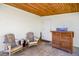 Covered porch with wood ceiling, seating, and a white brick accent wall at 902 Conrad Dr, New Smyrna Beach, FL 32168