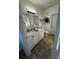 Bright bathroom with double sink vanity, granite countertop, two mirrors, and tile flooring at 911 N Orange Ave # 528, Orlando, FL 32801