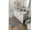Bright bathroom with double sink vanity, granite countertop, two mirrors, and tile flooring at 911 N Orange Ave # 528, Orlando, FL 32801