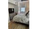 The bedroom has a ceiling fan, laminate flooring, and a dresser with a TV on top at 911 N Orange Ave # 528, Orlando, FL 32801