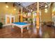 The recreational room features a bright blue pool table and wood laminate flooring at 911 N Orange Ave # 528, Orlando, FL 32801
