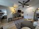 Cozy living room with modern ceiling fan and hardwood flooring, leading into the bedroom at 911 N Orange Ave # 528, Orlando, FL 32801