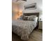 Comfortable main bedroom features a queen bed with patterned bedding and wood laminate flooring at 911 N Orange Ave # 528, Orlando, FL 32801
