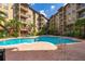 Resort-style swimming pool surrounded by lush landscaping and lounge chairs, ideal for relaxation and recreation at 911 N Orange Ave # 528, Orlando, FL 32801