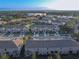 Scenic aerial view of townhomes with well-maintained landscaping and a backdrop of lush greenery at 94 Bella Vita Way, Ormond Beach, FL 32174