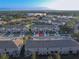 Scenic aerial view of townhomes with well-maintained landscaping and a backdrop of lush greenery at 94 Bella Vita Way, Ormond Beach, FL 32174