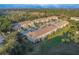 Aerial view showcases the rear of townhomes with green lawns and a screened lanai, highlighting outdoor living space at 94 Bella Vita Way, Ormond Beach, FL 32174