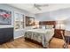 Comfortable bedroom features a queen bed, wood floors, and shuttered windows at 94 Bella Vita Way, Ormond Beach, FL 32174