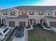 Charming townhome exterior with attached garages, complemented by manicured landscaping and inviting entrance at 94 Bella Vita Way, Ormond Beach, FL 32174
