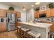 Modern kitchen with stainless steel appliances, island with seating, and stylish wood cabinets at 94 Bella Vita Way, Ormond Beach, FL 32174