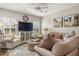 Comfortable living room with plush seating, neutral decor, and a large entertainment center at 94 Bella Vita Way, Ormond Beach, FL 32174