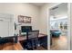 Bright office with hardwood floors features an open doorway to a light and airy bedroom at 94 Bella Vita Way, Ormond Beach, FL 32174