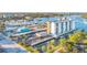 Aerial view of the waterfront condominium with boat docks, surrounded by palm trees and the bay at 101 N Riverside Dr # 214, New Smyrna Beach, FL 32169