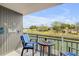 Relax on this charming balcony overlooking a scenic canal view, complete with comfortable seating and serene ambiance at 101 N Riverside Dr # 214, New Smyrna Beach, FL 32169