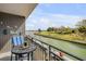 Unwind on the private balcony with waterway views, equipped with a table and chair set, perfect for enjoying the outdoors at 101 N Riverside Dr # 214, New Smyrna Beach, FL 32169