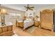 Charming bedroom featuring hardwood floors, a unique ceiling fan, and a cozy wooden bed frame at 101 N Riverside Dr # 214, New Smyrna Beach, FL 32169