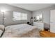 Well-lit bedroom showcasing hardwood floors and a calming color palette, creating a relaxing atmosphere at 101 N Riverside Dr # 214, New Smyrna Beach, FL 32169