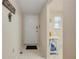 Condo hallway leading to a white door and an adjacent dining nook with a white table at 101 N Riverside Dr # 214, New Smyrna Beach, FL 32169