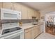 Bright kitchen featuring white appliances and stone-look countertops at 101 N Riverside Dr # 214, New Smyrna Beach, FL 32169