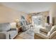 Comfortable living room area with a balcony and nice furnishings at 101 N Riverside Dr # 214, New Smyrna Beach, FL 32169
