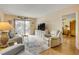 Bright living room featuring a balcony, comfortable seating, and television at 101 N Riverside Dr # 214, New Smyrna Beach, FL 32169