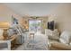 Bright living room with balcony access and modern television at 101 N Riverside Dr # 214, New Smyrna Beach, FL 32169