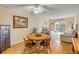 Comfortable living and dining area with a ceiling fan and sliding door to the balcony at 101 N Riverside Dr # 214, New Smyrna Beach, FL 32169