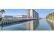 Condominium building with boat docks along the water, featuring clear reflections on a sunny day at 101 N Riverside Dr # 214, New Smyrna Beach, FL 32169