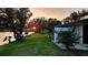 Beautiful sunset view overlooking a lush green lawn and tranquil lake at 108 Lake Fairgreen Cir, New Smyrna Beach, FL 32168