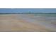 Scenic beach view with tranquil waters and a distant lighthouse at 108 Lake Fairgreen Cir, New Smyrna Beach, FL 32168