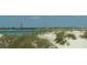 Scenic beach view with the lighthouse in the distance at 108 Lake Fairgreen Cir, New Smyrna Beach, FL 32168