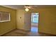 Bright bedroom with yellow walls, ceiling fan, and waterfront views beyond at 108 Lake Fairgreen Cir, New Smyrna Beach, FL 32168