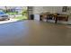 View of the spacious garage featuring epoxy flooring, open garage door and built in work bench at 108 Lake Fairgreen Cir, New Smyrna Beach, FL 32168