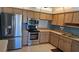 Updated kitchen featuring stainless steel appliances, tile floors, and plentiful wood cabinets at 108 Lake Fairgreen Cir, New Smyrna Beach, FL 32168