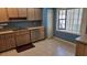 The kitchen features tile flooring, wood cabinets, and stainless-steel dishwasher at 108 Lake Fairgreen Cir, New Smyrna Beach, FL 32168