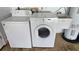 Functional laundry room with appliances, sink and water heater on the floor at 108 Lake Fairgreen Cir, New Smyrna Beach, FL 32168