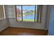 Sunroom area with wood floors and waterfront view at 108 Lake Fairgreen Cir, New Smyrna Beach, FL 32168