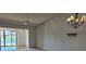 Bright living area with waterfront view and chandelier at 108 Lake Fairgreen Cir, New Smyrna Beach, FL 32168