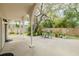 Inviting back porch with a concrete floor, a table and chairs, and a view of the lush backyard at 111 Esther St, New Smyrna Beach, FL 32169