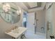 Modern bathroom with glass shower, vanity, patterned tile flooring, and elegant fixtures at 111 Esther St, New Smyrna Beach, FL 32169
