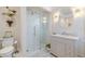 Modern bathroom with glass shower, vanity, toilet, and patterned tile flooring at 111 Esther St, New Smyrna Beach, FL 32169
