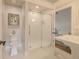Bright bathroom featuring a glass shower, white tile, toilet, and elegant fixtures at 111 Esther St, New Smyrna Beach, FL 32169